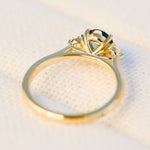 tanzanian oval teal sapphire trilogy engagement ring in yellow gold