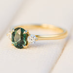 tanzanian oval teal sapphire trilogy engagement ring in yellow gold