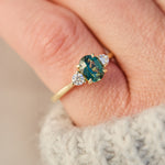 tanzanian oval teal sapphire trilogy engagement ring in yellow gold
