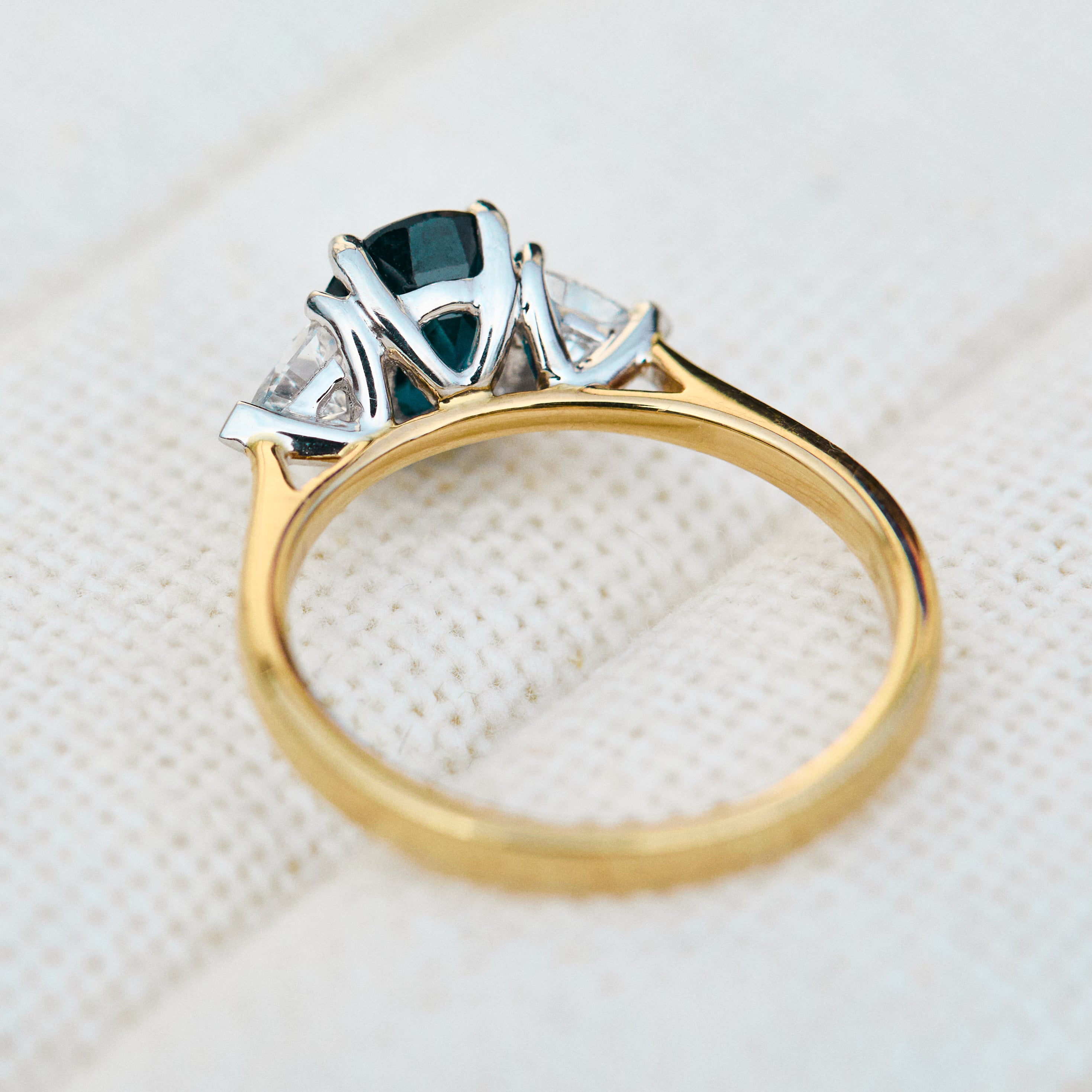 teal blue oval sapphire yellow gold and platinum engagement ring
