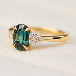oval teal green sapphire and diamonds gold engagement ring