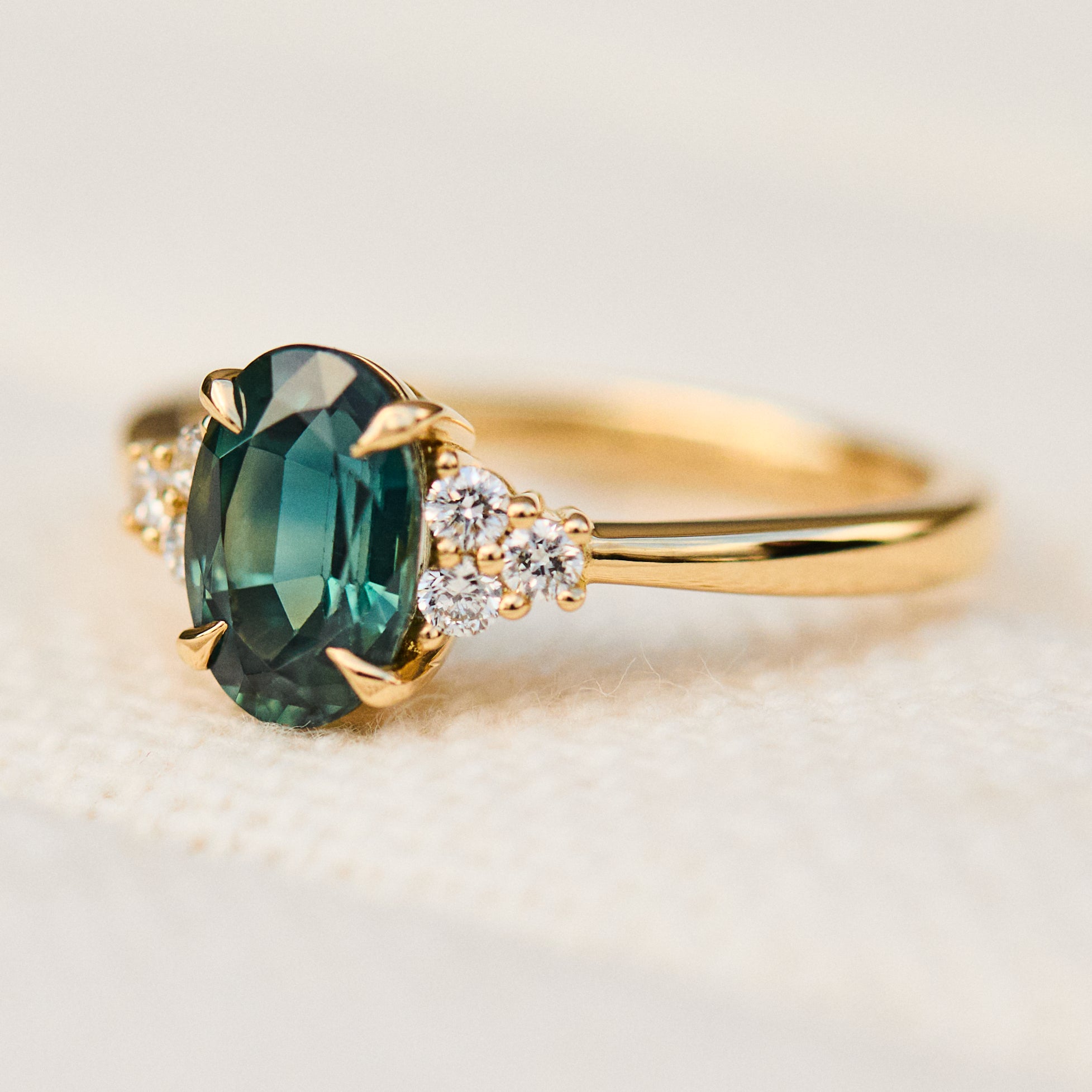 oval teal green sapphire and diamonds gold engagement ring