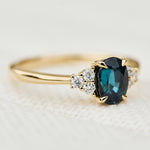 oval teal sapphire yellow gold engagement ring