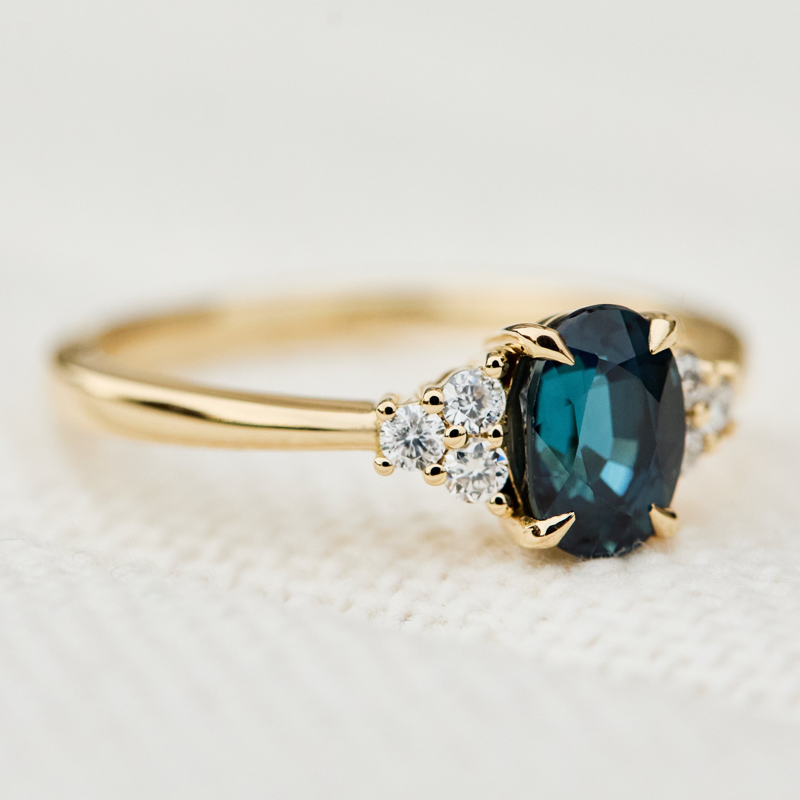 oval teal sapphire yellow gold engagement ring