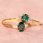 trilogy yellow gold rings with teal sapphires