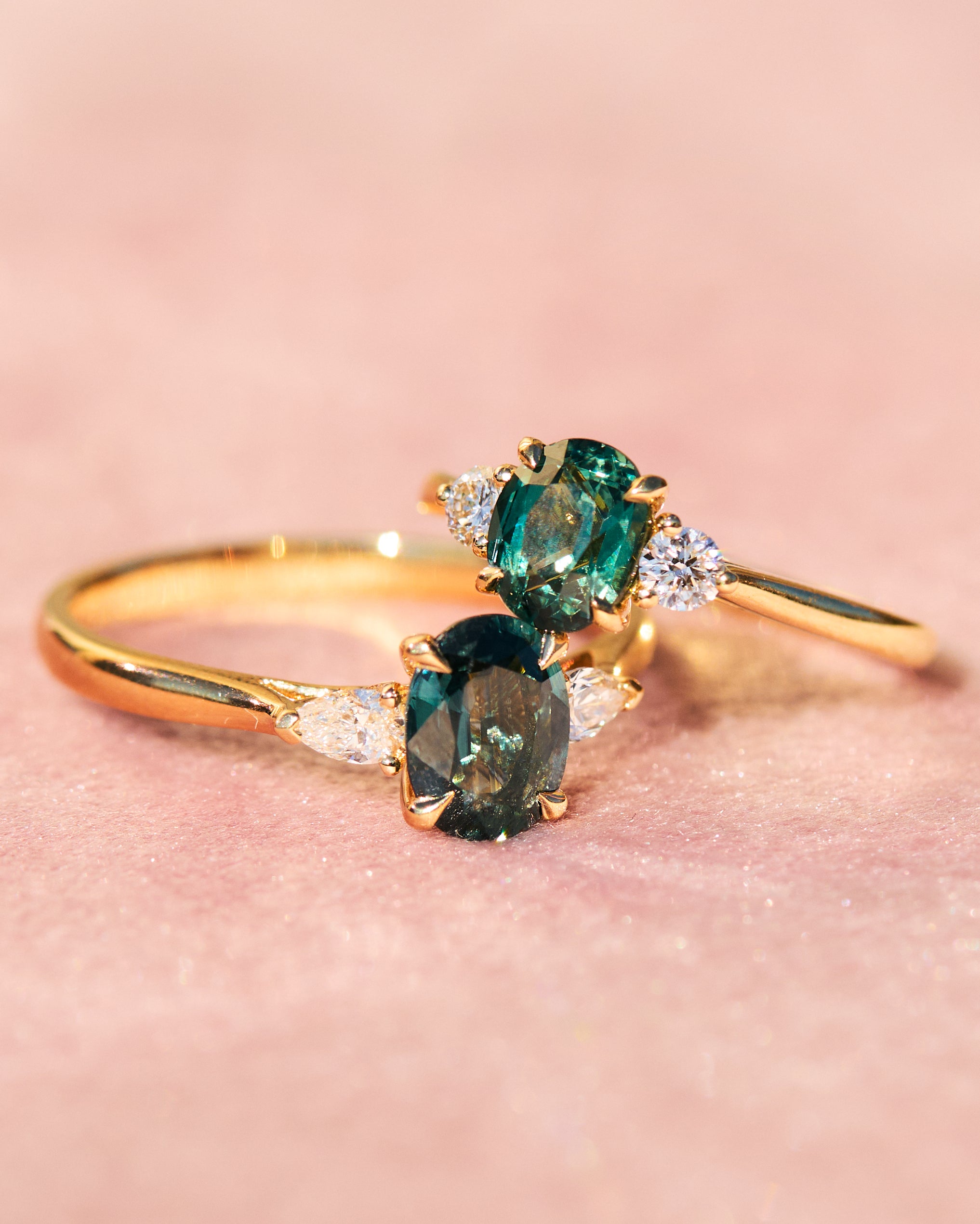 trilogy yellow gold rings with teal sapphires