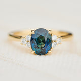 unheated teal blue oval sapphire engagement ring in yellow gold