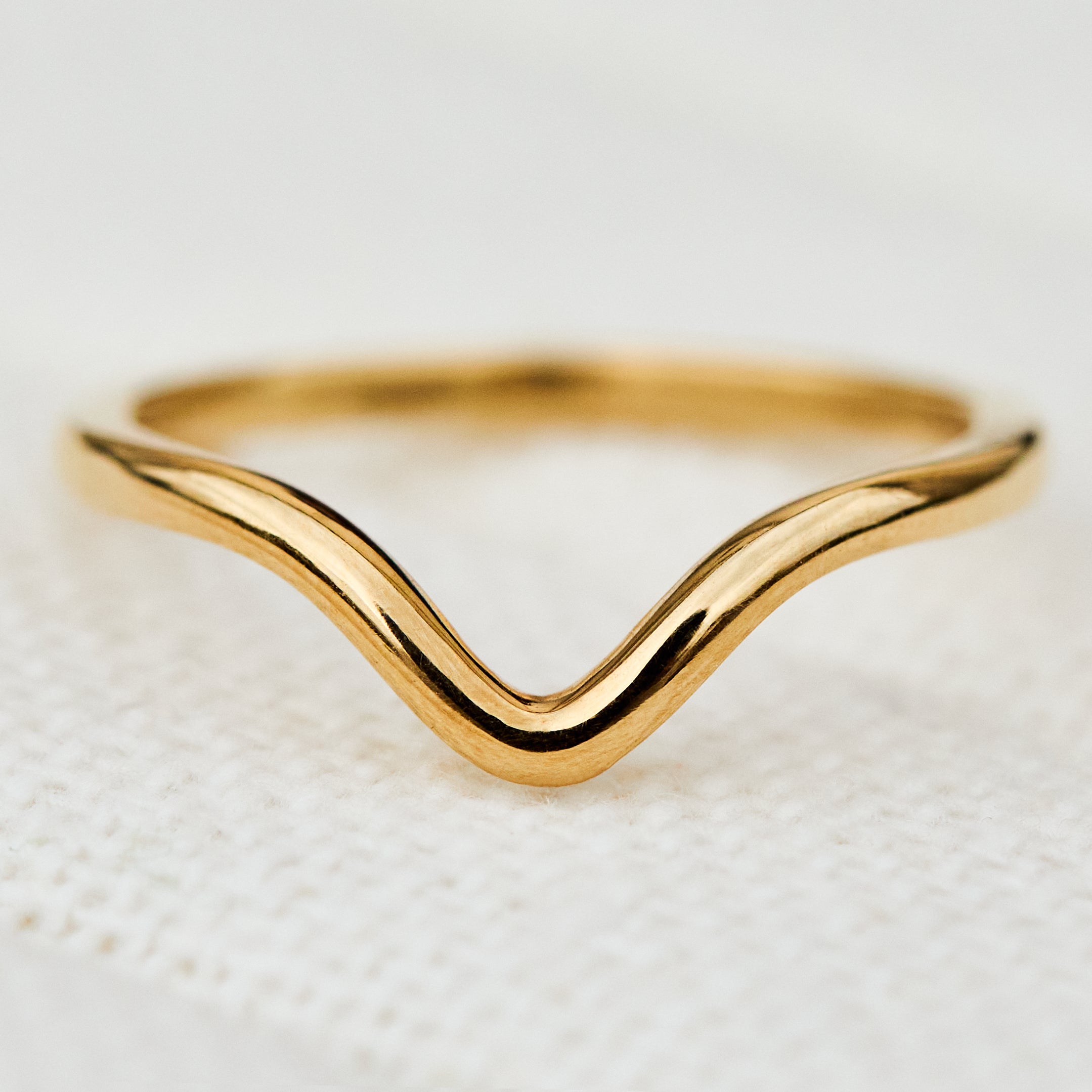 yara curved wedding band in yellow gold