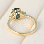 australian oval teal sapphire engagement ring with round diamond side stones
