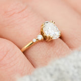 cushion cut moissanite and diamond engagement ring in yellow gold