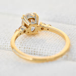 cushion cut moissanite and diamond engagement ring in yellow gold