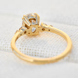cushion cut moissanite and diamond engagement ring in yellow gold