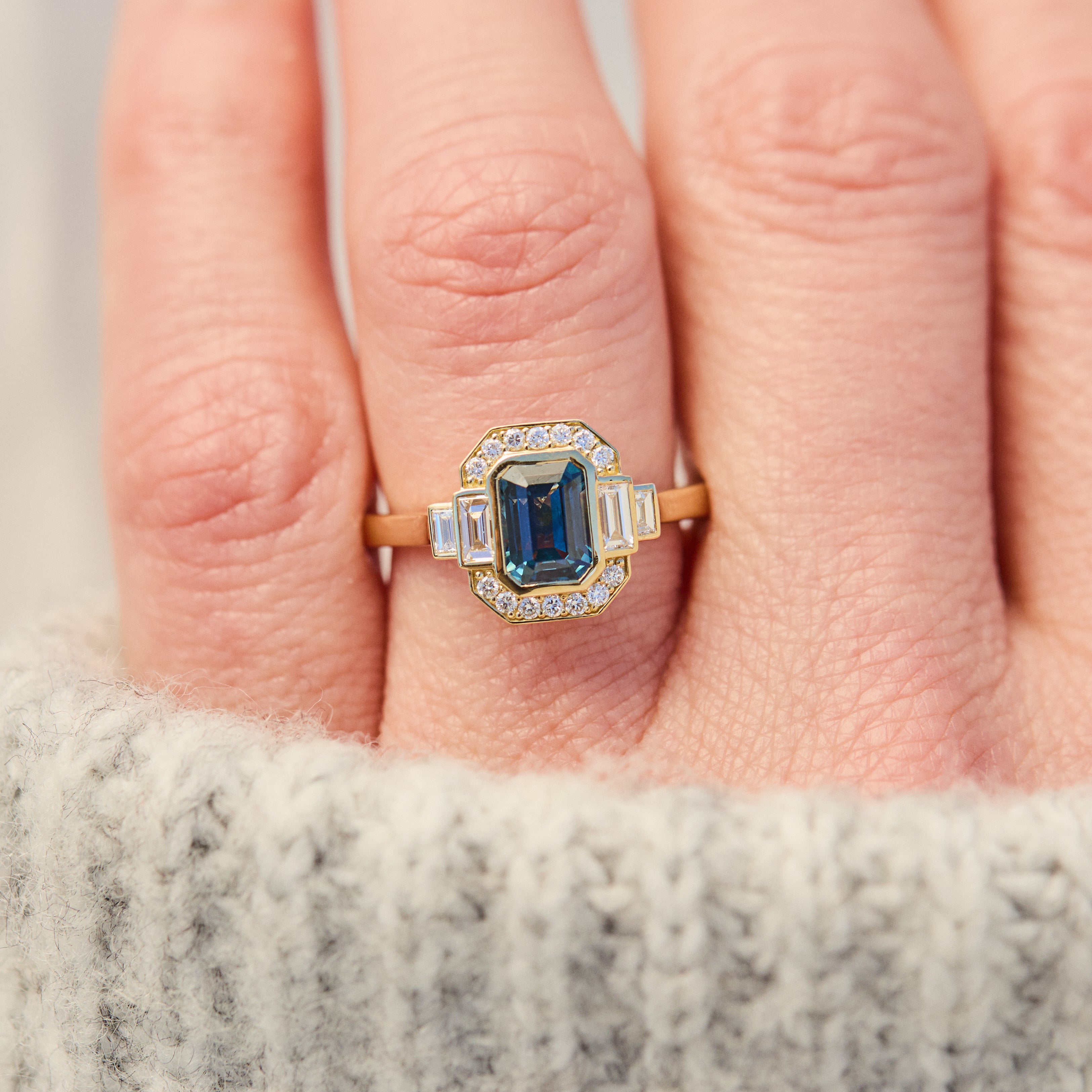 emerald cut blue sapphire one of a kind engagement ring in yellow gold