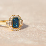 yellow gold engagement ring with a blue sapphire 