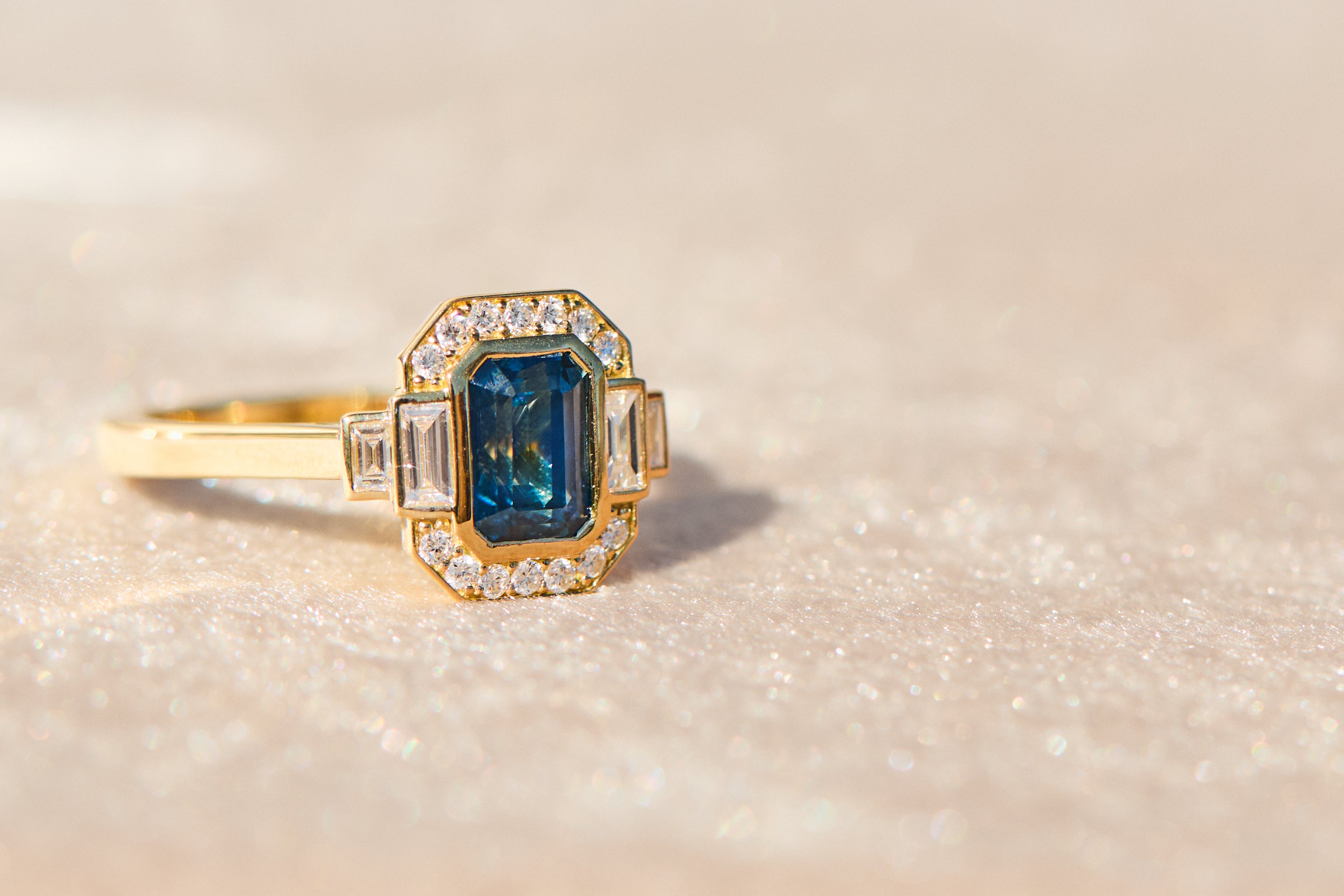 yellow gold engagement ring with a blue sapphire 