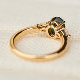 oval green sapphire trilogy engagement ring in yellow gold