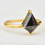yellow gold solitaire ring with a kite shape salt and pepper diamond