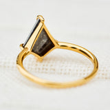 yellow gold solitaire ring with a kite shape salt and pepper diamond