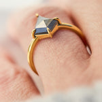 yellow gold solitaire ring with a kite shape salt and pepper diamond