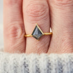 yellow gold solitaire ring with a kite shape salt and pepper diamond