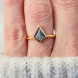 yellow gold solitaire ring with a kite shape salt and pepper diamond