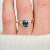 unheated teal blue oval sapphire engagement ring in yellow gold