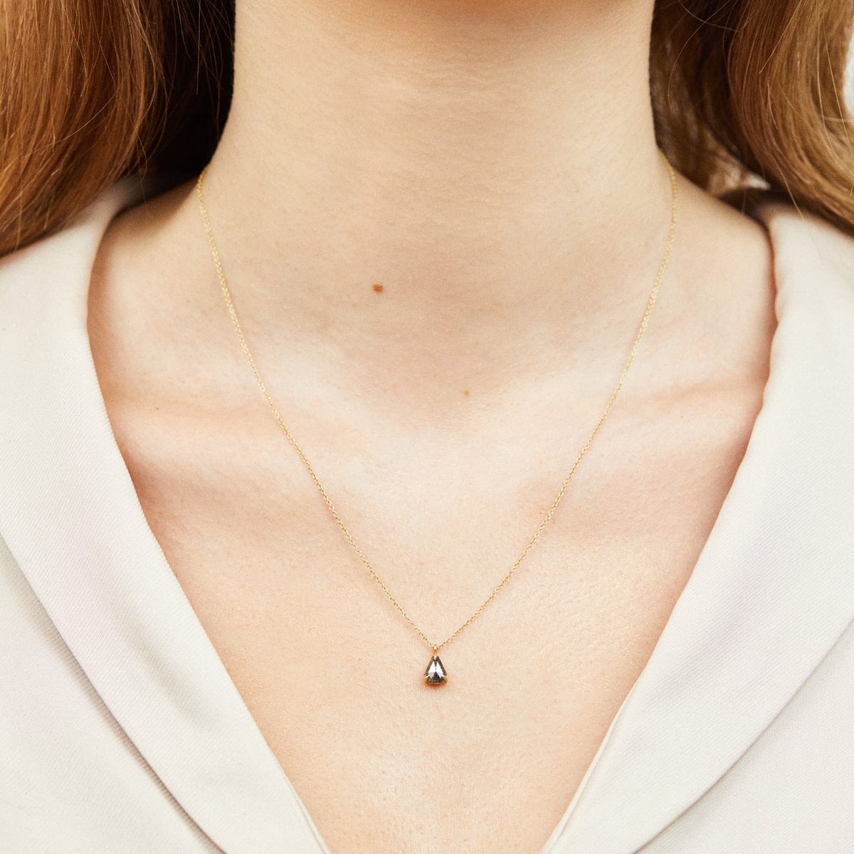 Geometric black triangular diamond necklace in 18ct yellow gold.