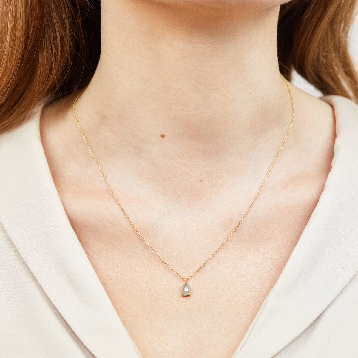 Icy grey shield-shaped diamond necklace in 18ct yellow gold.