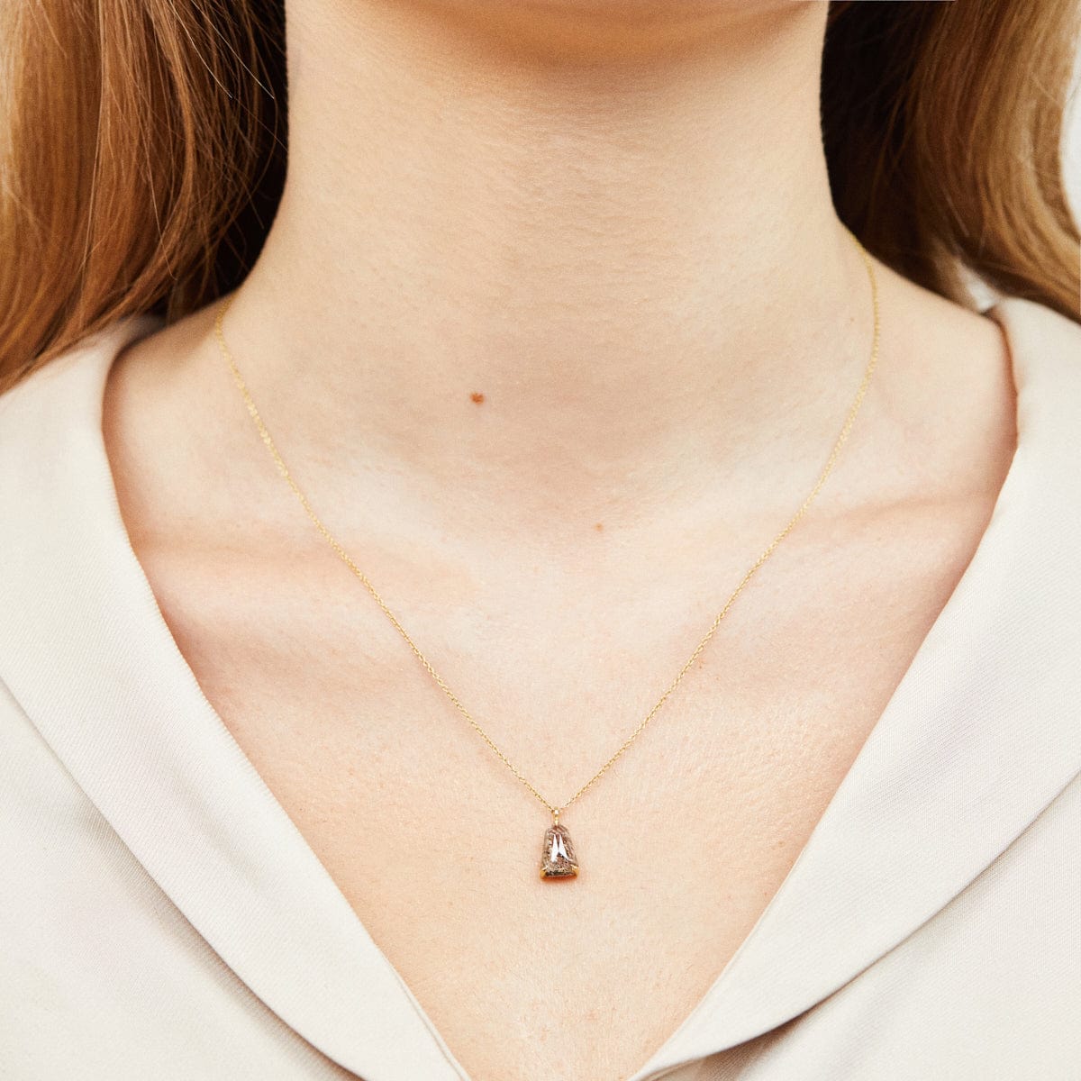Shield-shaped salt and pepper diamond necklace in 18ct yellow gold.