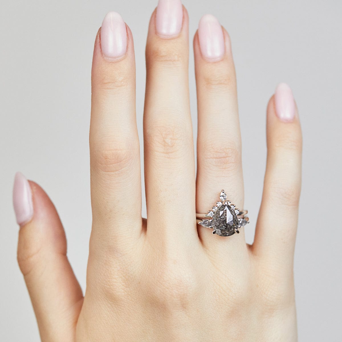 Platinum salt and pepper pear diamond engagement trilogy ring