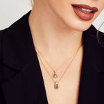 Grey pear-shaped salt and pepper diamond necklace in 18ct yellow gold.