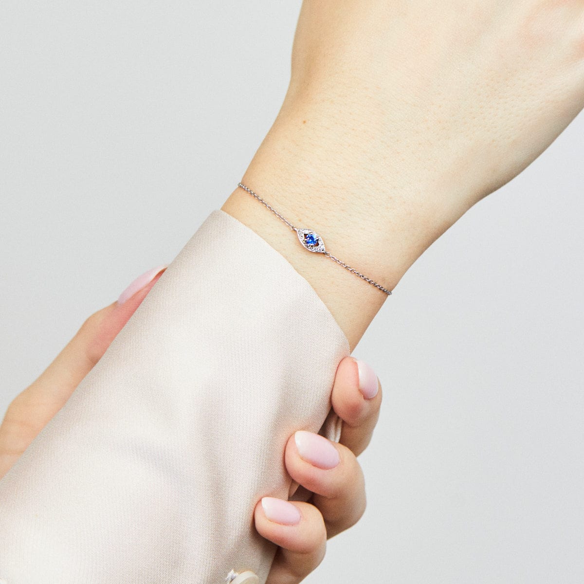 Sapphire evil eye bracelet with diamonds in 18ct white gold.