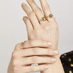Hexagon-shaped diamond engagement ring with a gold band and round diamonds