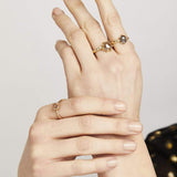 Hexagon-shaped diamond engagement ring with a gold band and round diamonds