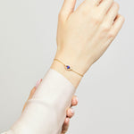 Blue sapphire evil eye bracelet with diamonds in 18ct yellow gold.