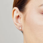 White baguette-cut lab-grown diamond earrings set in 18ct yellow gold.