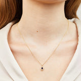 Blue sapphire evil eye necklace with diamonds in 18ct yellow gold.